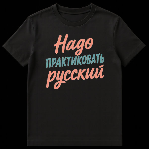 Close-up of a t-shirt featuring three lines of Russian text: 'Надо' in coral pink script, 'практиковать' in teal sans-serif, and 'русский' in coral pink script. on Black t-shirt